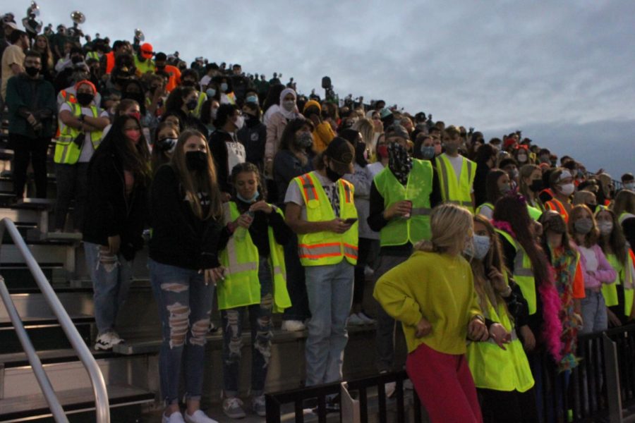 Students on senior night don neon colors instead of the normal college merchandise.