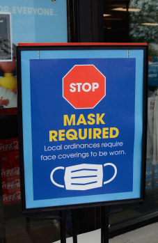 A sign at the Winchester Kroger reminds customers that masks are required to enter the store. Kentucky Gov. Andy Beshear has issued an order mandating face coverings, but starting Wednesday, Kroger stores nationwide are also requiring it.