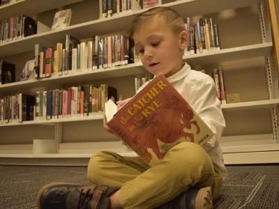 4-year-old Braeden LaDeaux reading Catcher in the Rye. 
