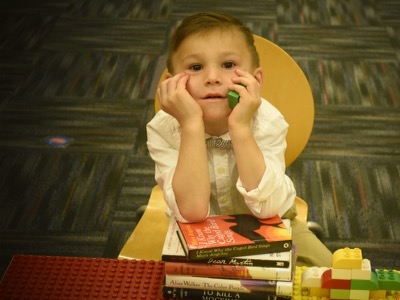 4 -year-old Braeden LaDeaux resting upon banned books