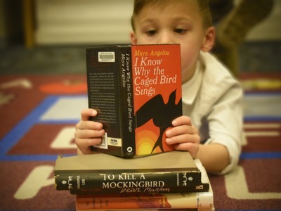 4-year-old Braeden LaDeaux reads a book often banned in schools. 