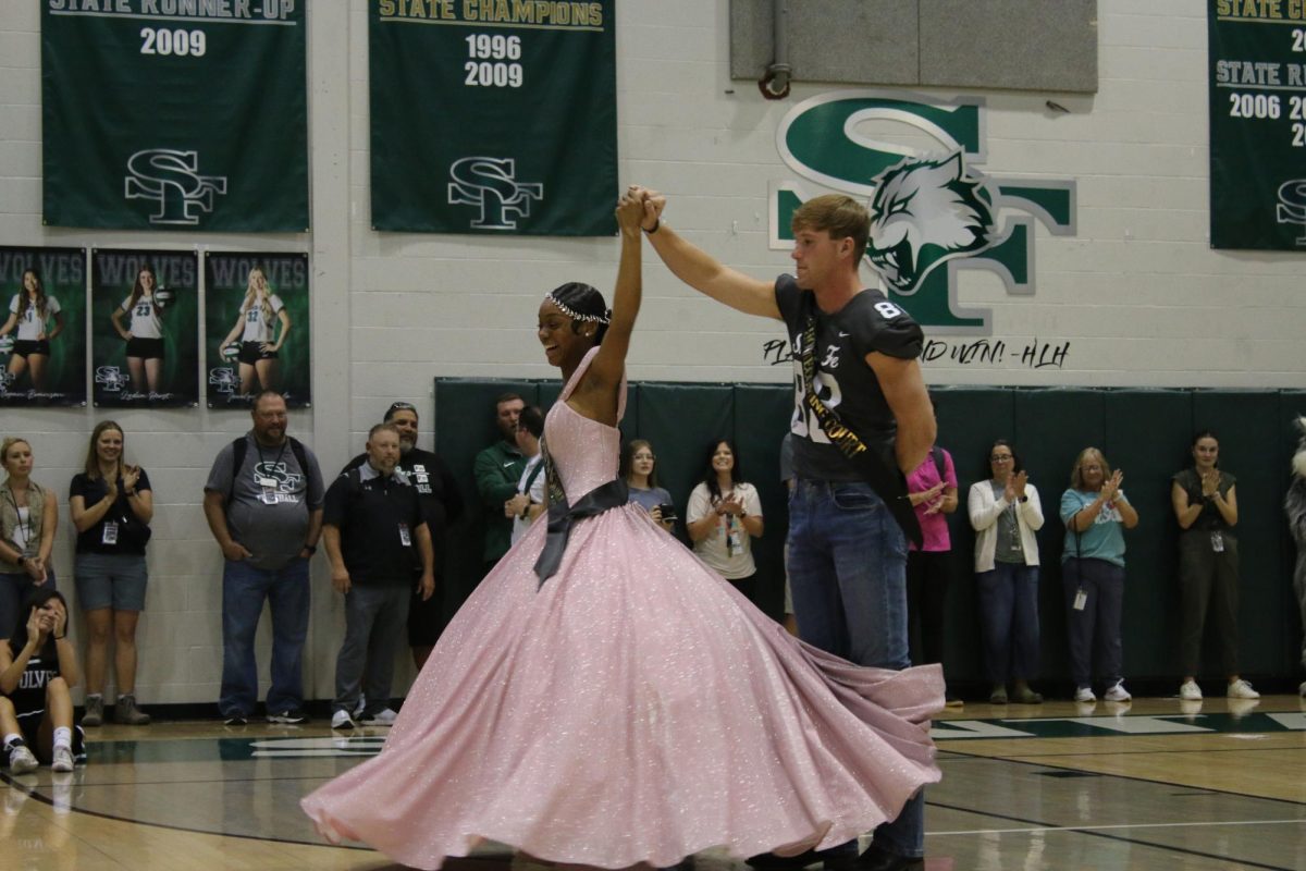 Give us a twirl! Homecoming queen and king celebrate their win.
