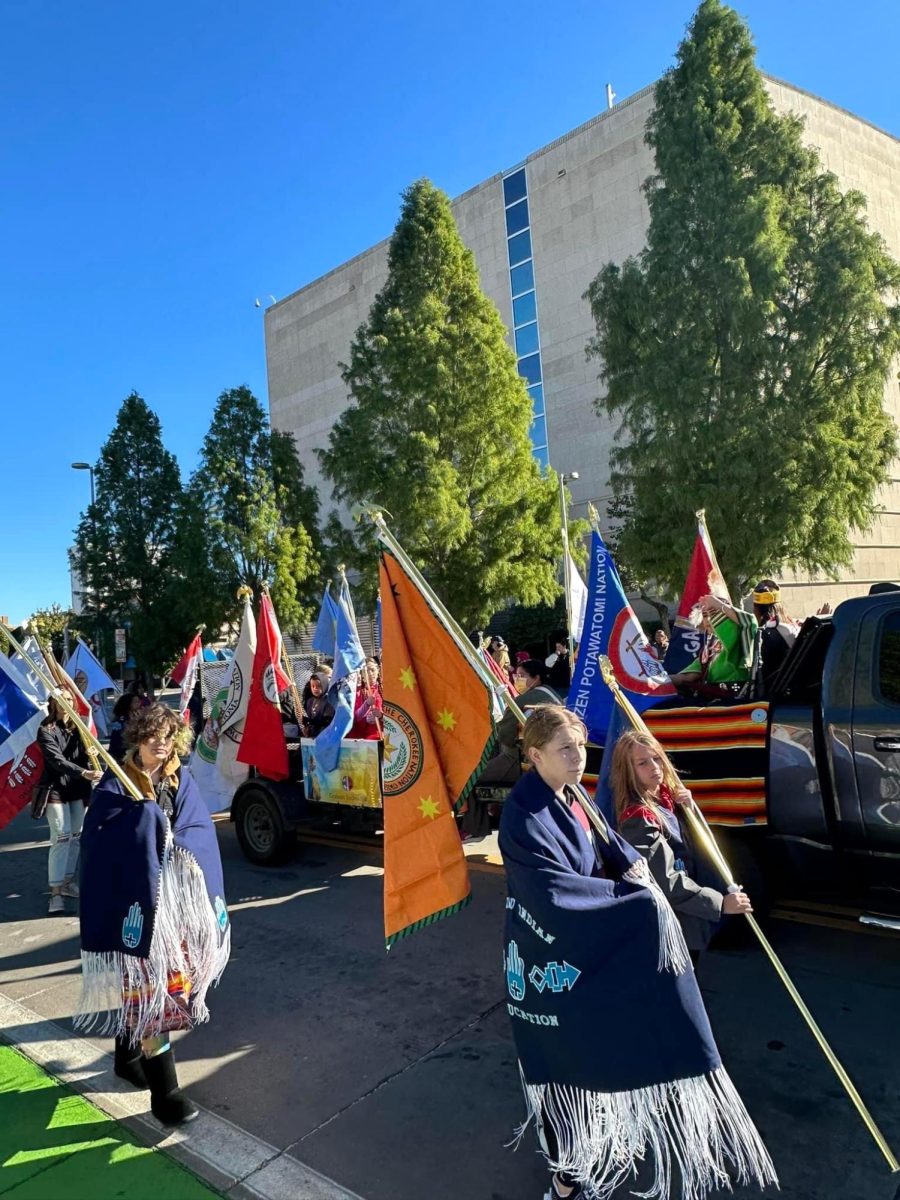 Edmond Indian Ed. Club in the Red Earth OKC Parade holding the 39 tribes flags of Oklahoma (Okla Homma).