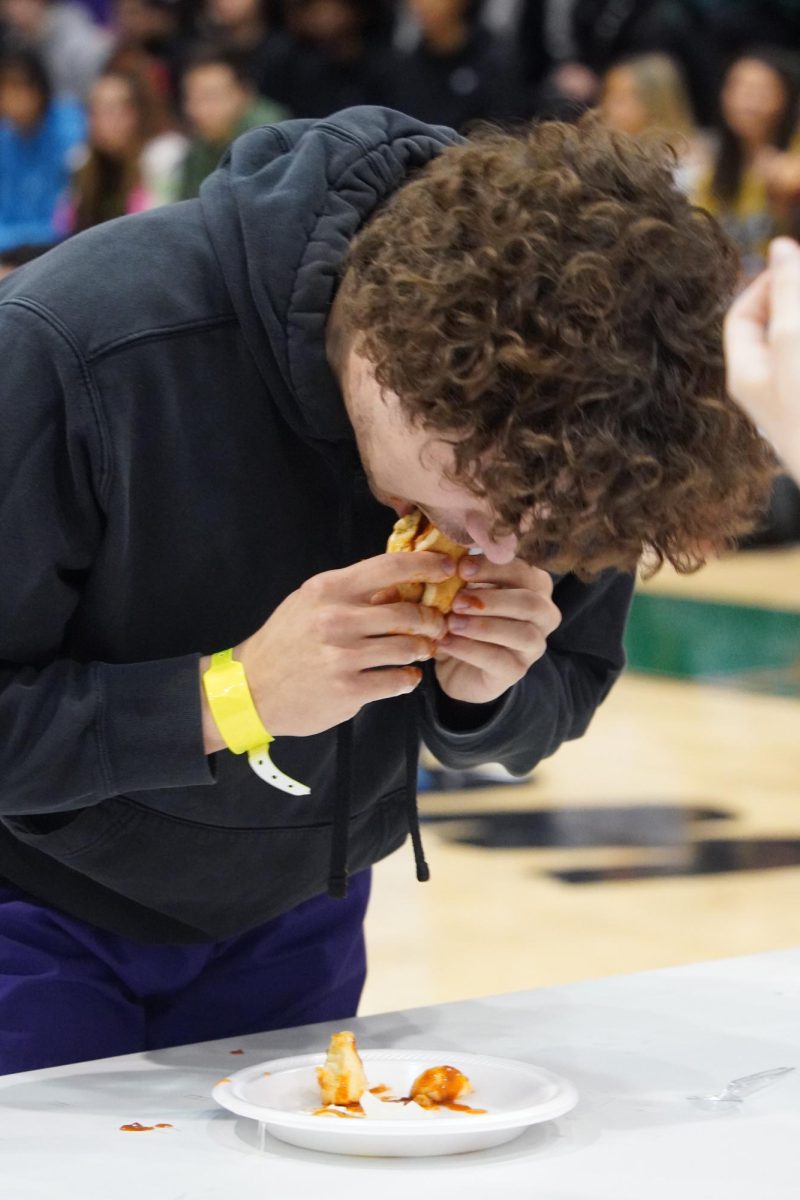 Eli Fina eating a disgusting hot dog in the Dare Assembly.  