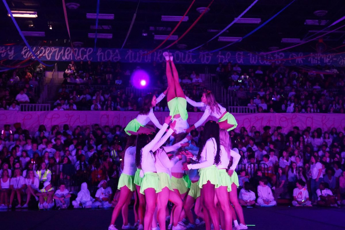 Cheer stunting during their Blacklight performance. 