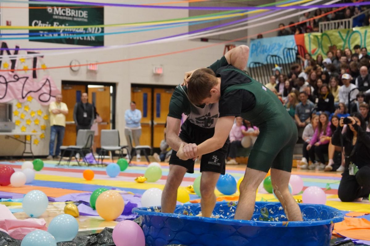 Two teacher wrestling each other in a tub of mashed potatoes. 