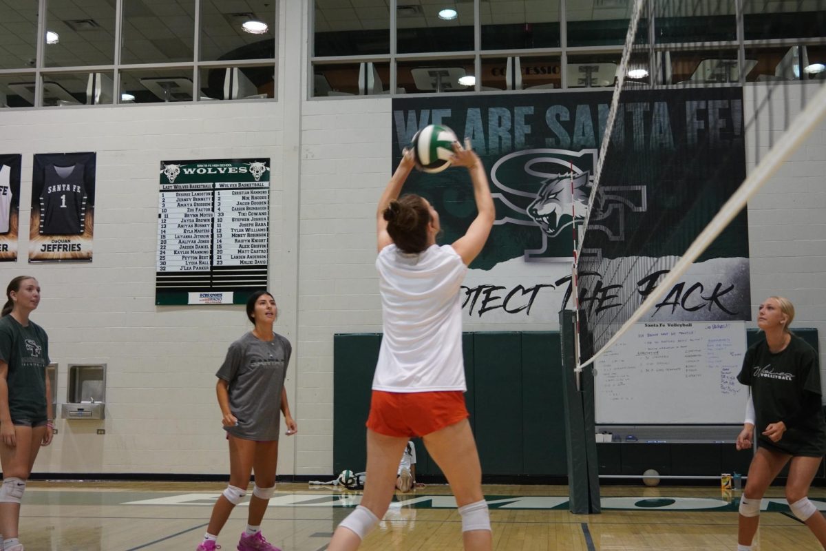 Anna Rice, senior, sets the ball to her teammates during warmups.