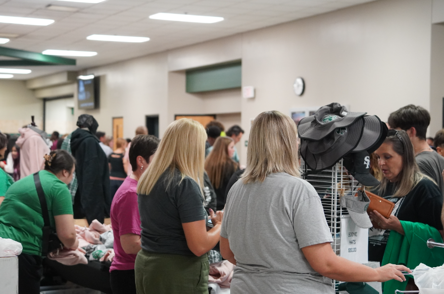 Santa Fe Wolf parents selling merchandise to new parents and freshmen. 