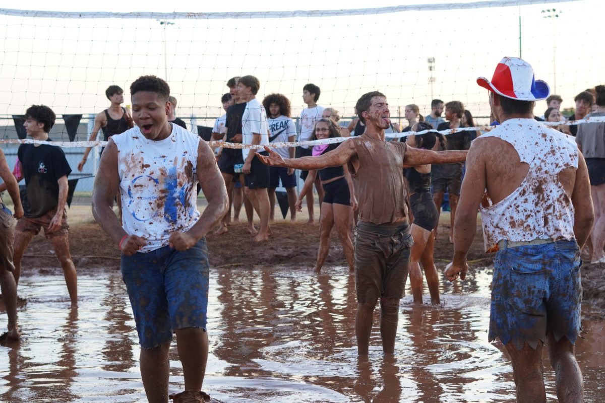 Jarell Hull celebrating a point in mud Volleyball.