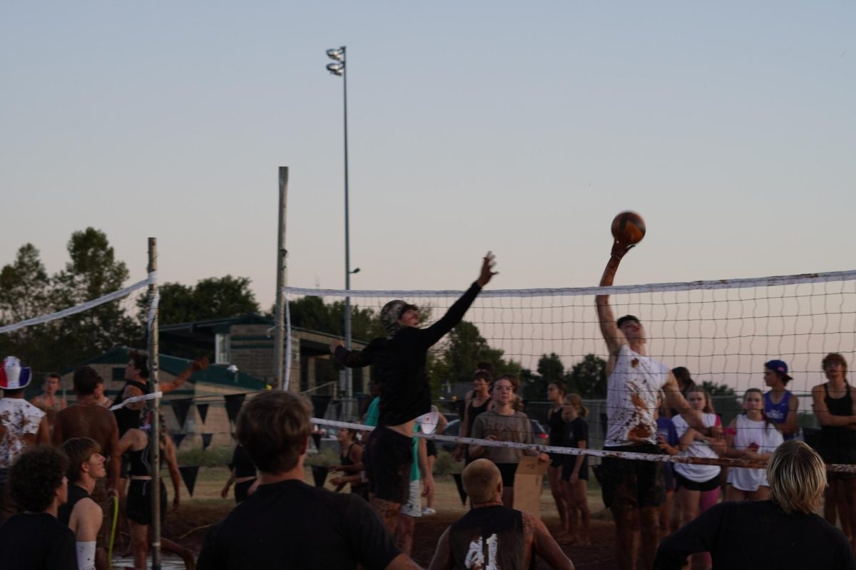 Alex Griffin spiking the ball at mud Volleyball.