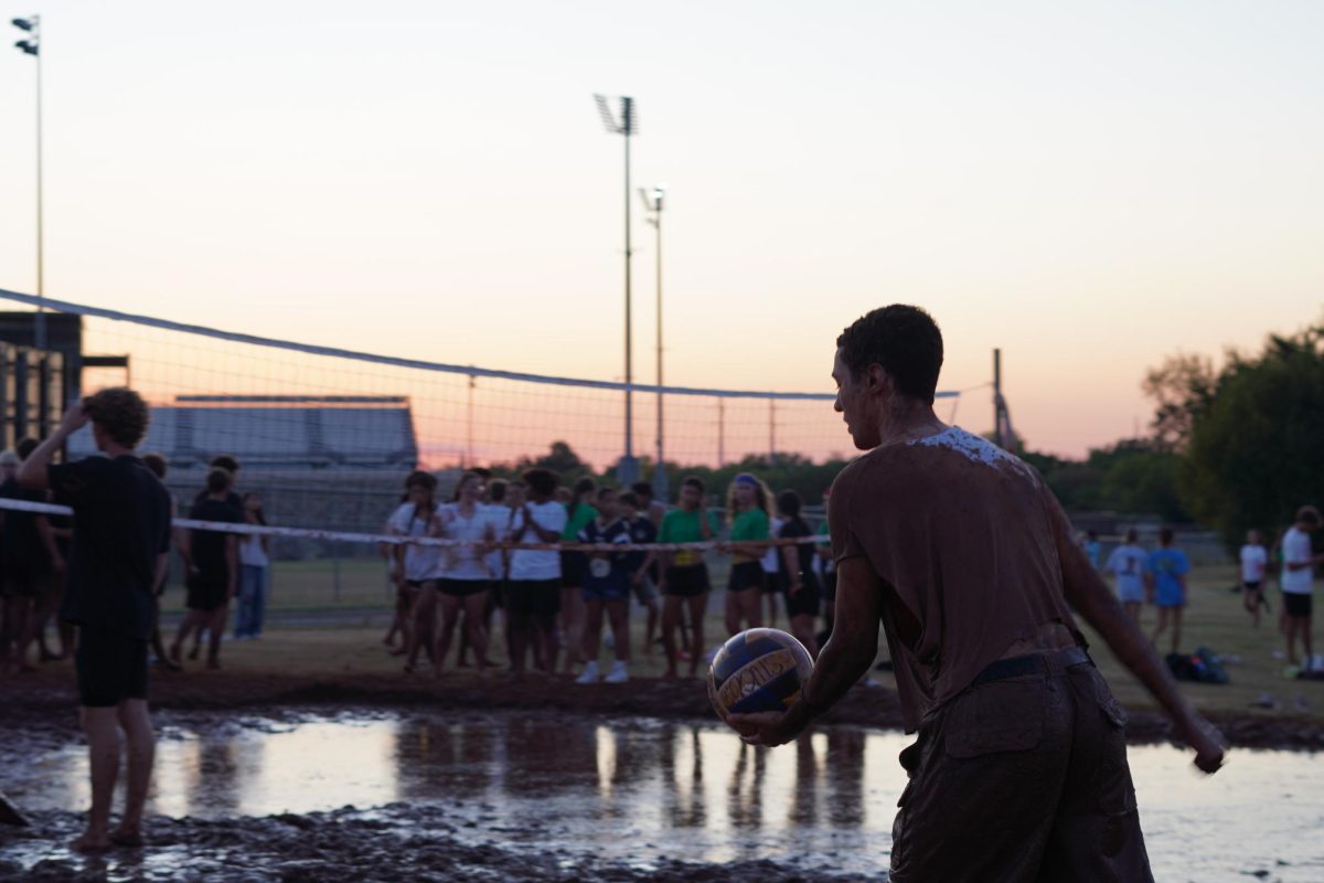 Ian Jenkins serving at mud Volleyball.