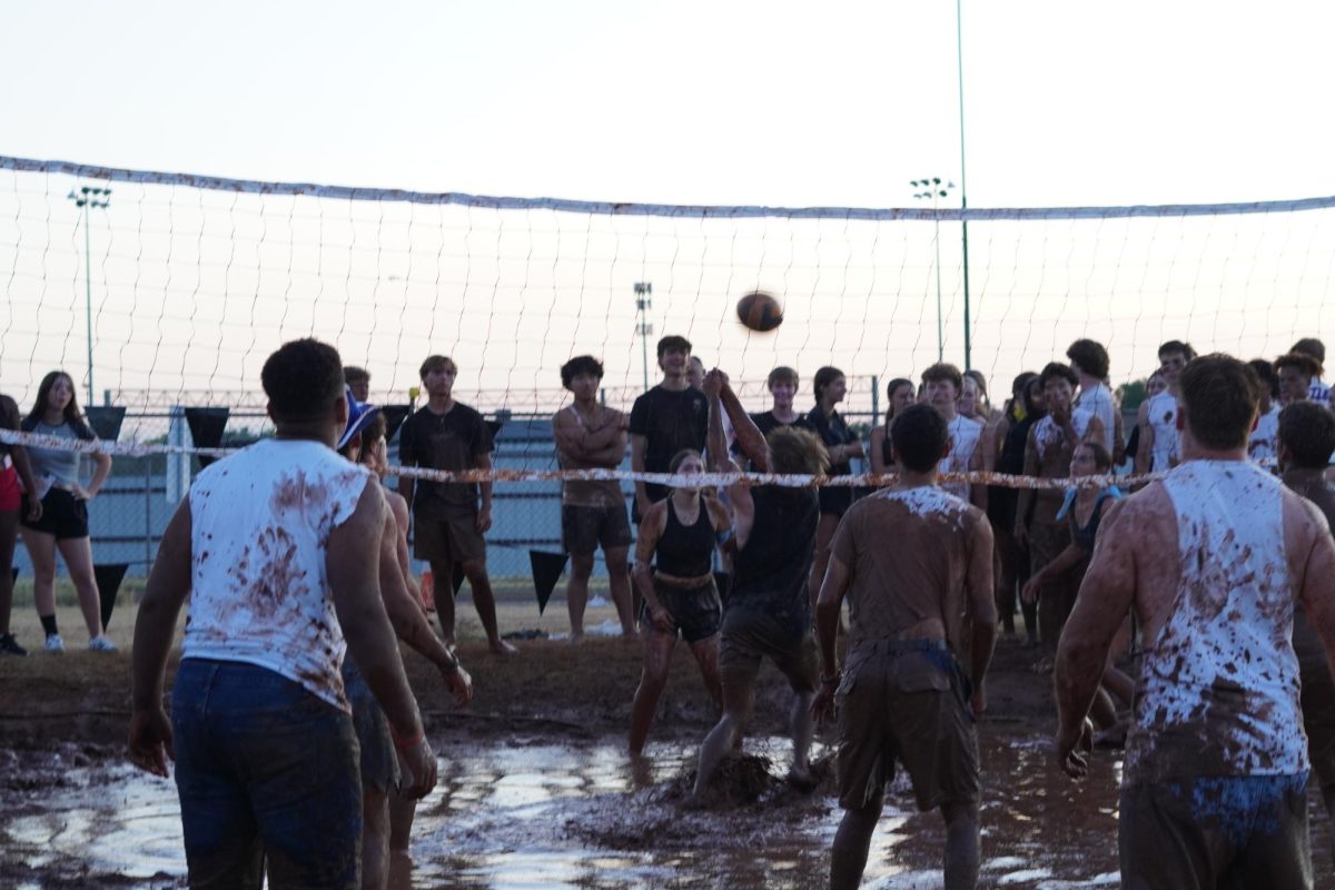 Mud Volleyball player passing the ball.