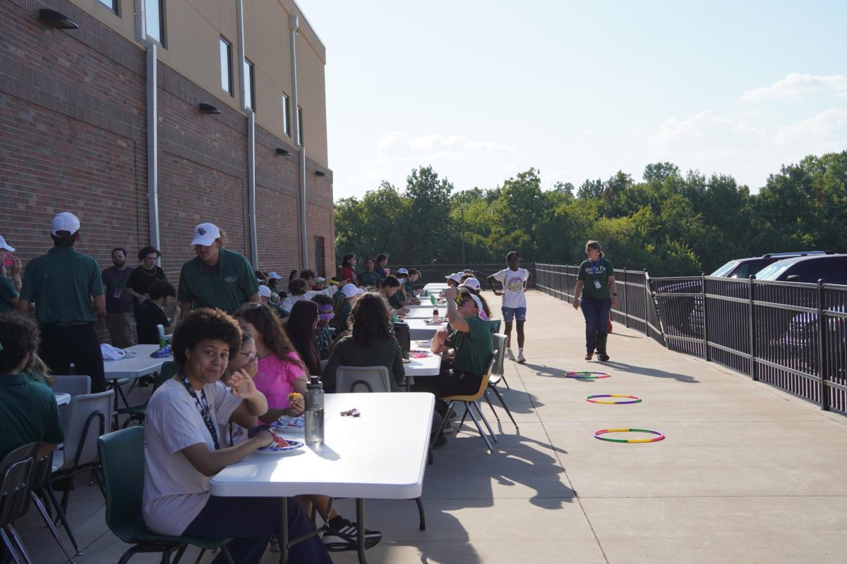 Fine Arts students enjoying hot dogs at the tailgate.