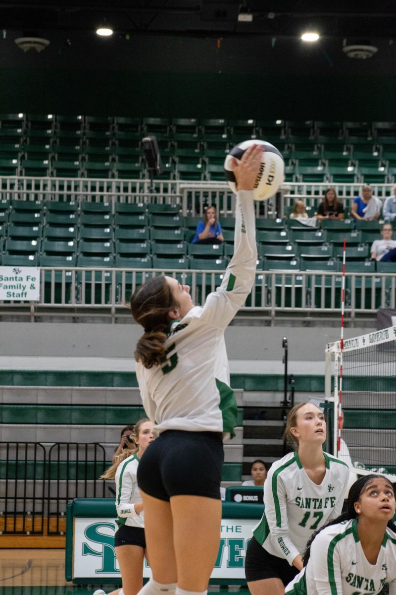 Tilly Combs hitting the ball to the other team.