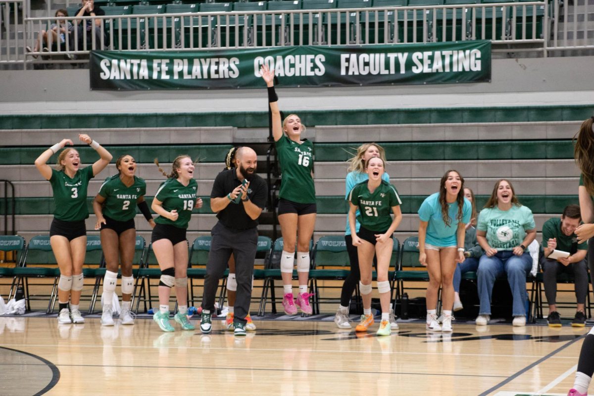 Varsity Team and coach McCarty cheering.