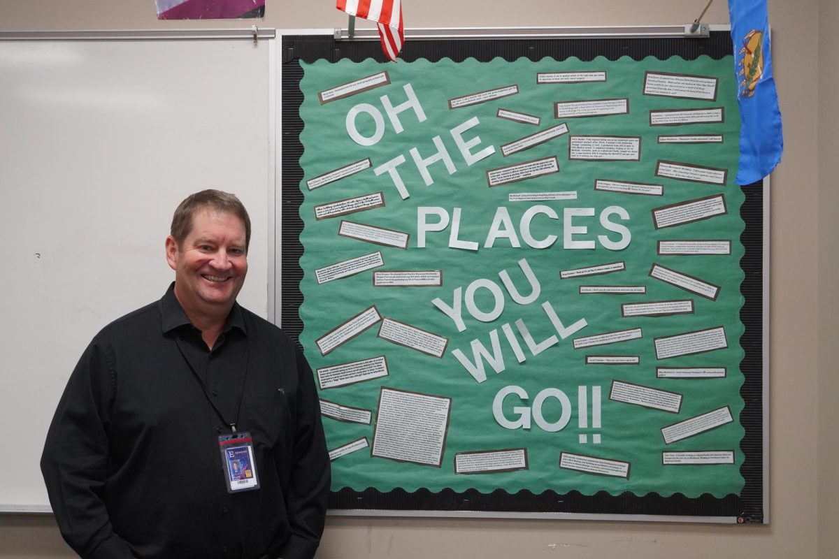 AP Government teacher, Mr. Williams standing next to his board of opportunities.