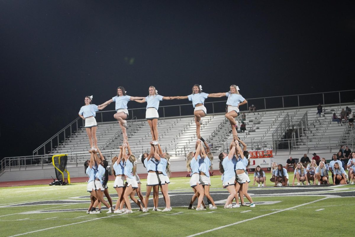 Cheer team performing at the Santa Fe homecoming game.