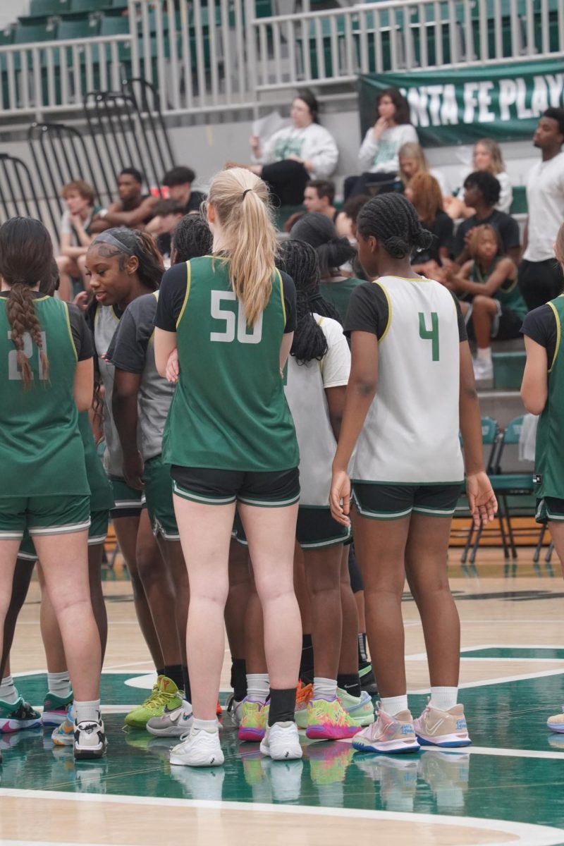 Haddley Otto (left) and Aishat Naallah (right) in a huddle.