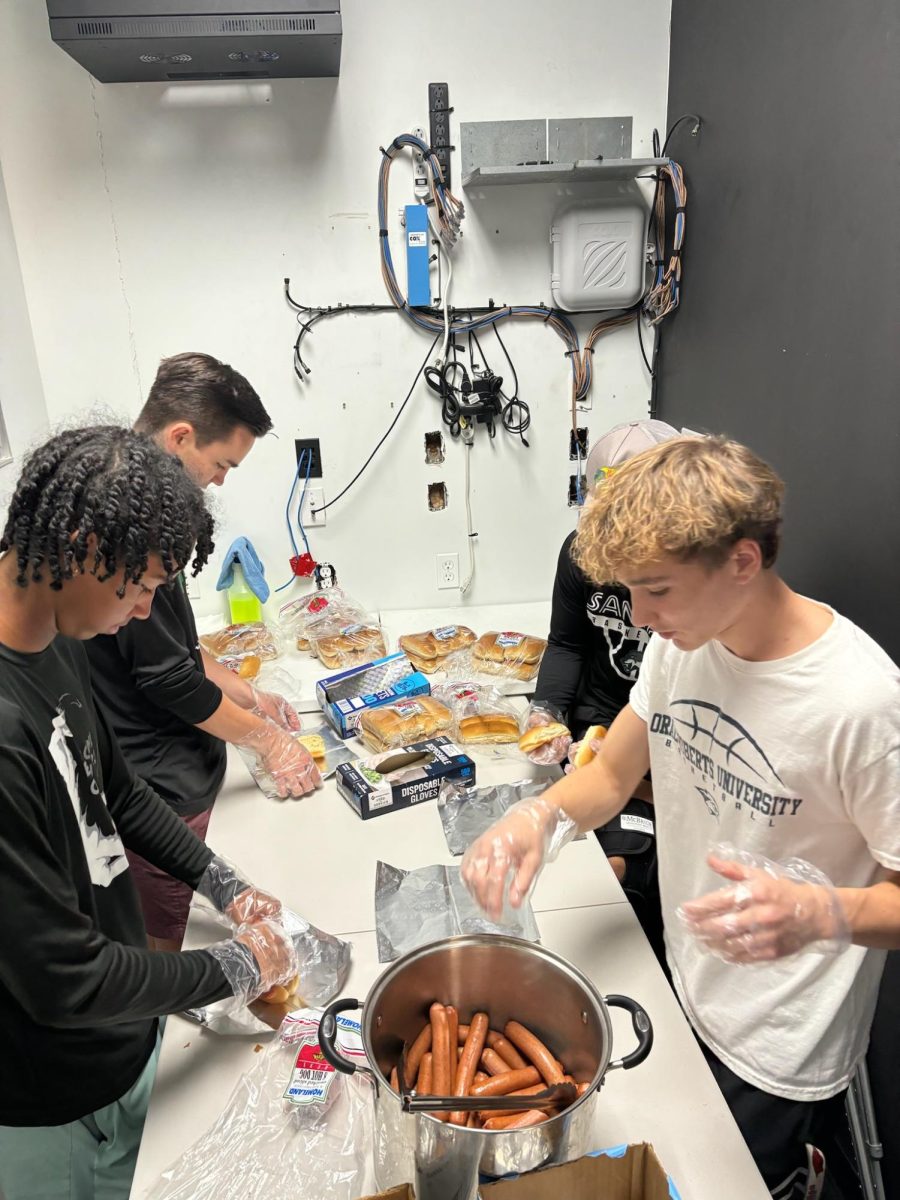 Wolves preparing hot dogs for the sack lunches.