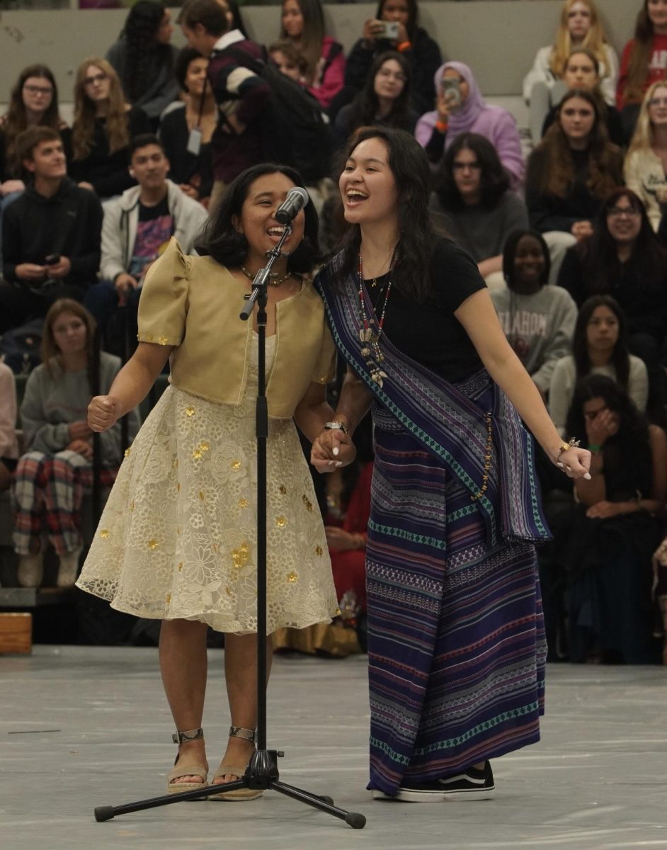 Senior Melanie Redwine and sophomore Dana Manuel representing the Philippines in the fashion show.