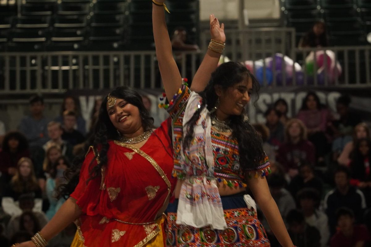 Senior Diya Patel and sophomore Pari Mattewada dancing during the assembly. 