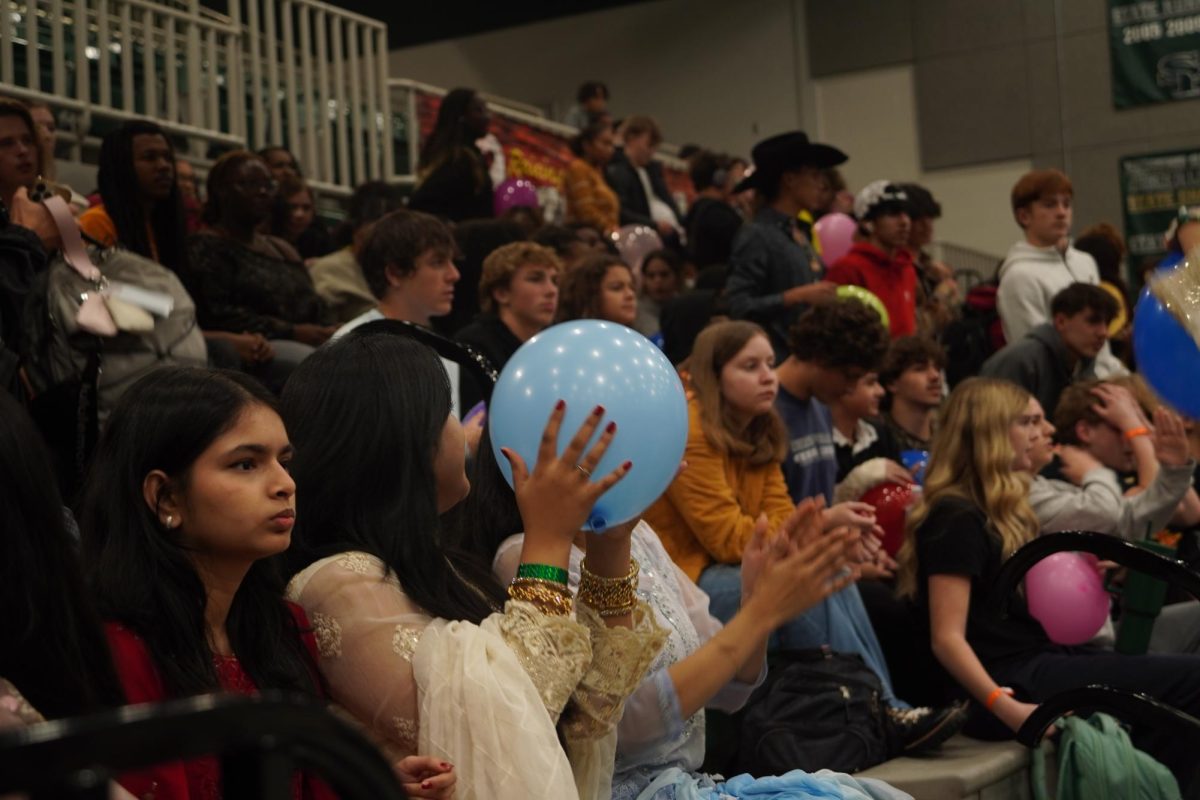 Students catching balloons STUCO released, concluding the culture assembly.