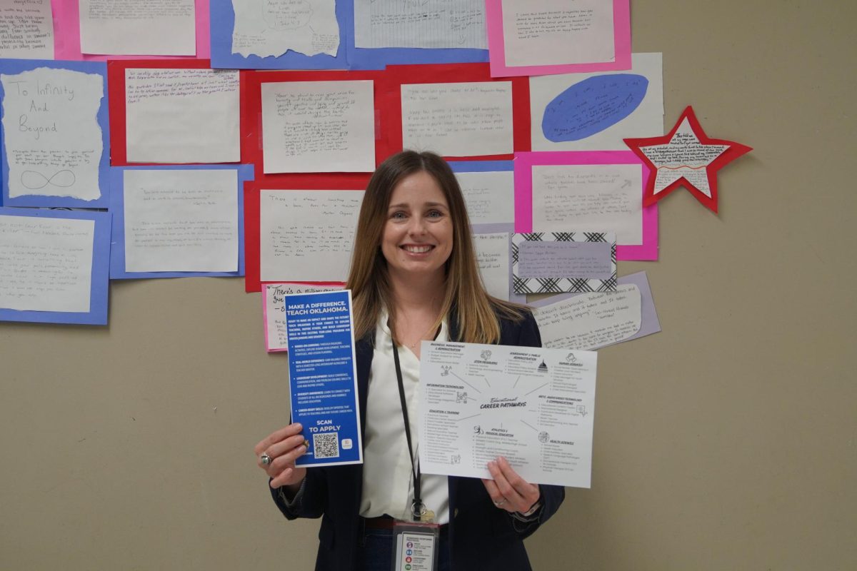 English and Teach Oklahoma teacher Amelia Prince, holding the sign up slip and all the information needed for Teach Oklahoma.