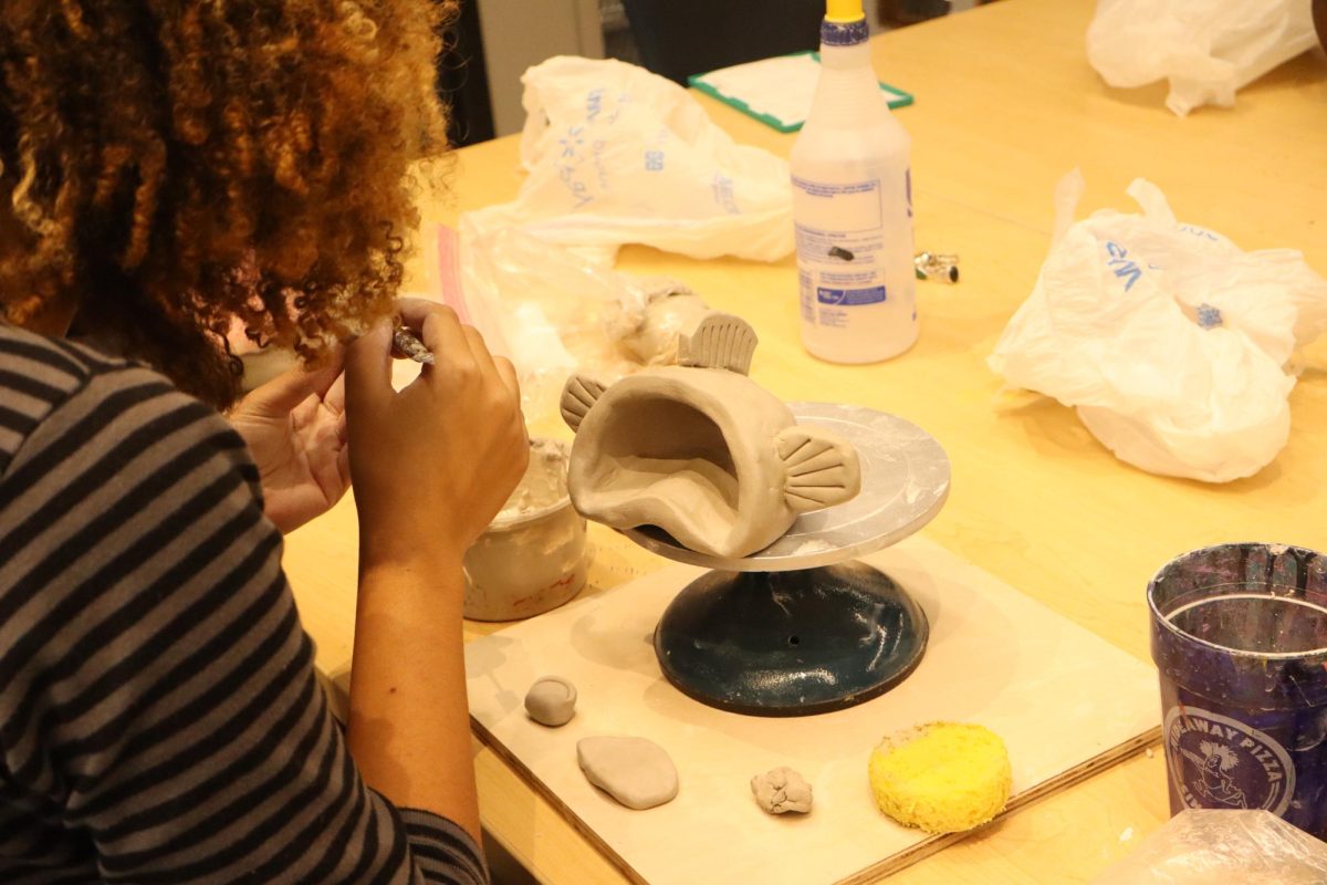 Senior Meah Golson working on ceramics project.