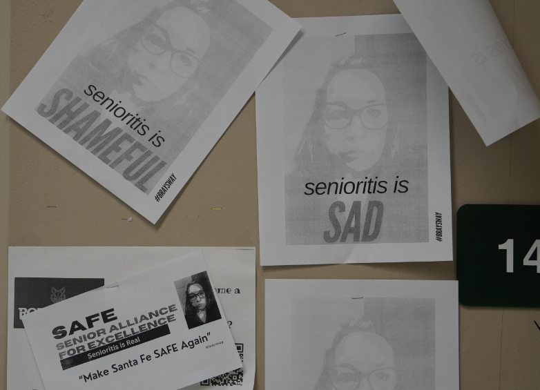 Stephanie Bray posts posters around the school displaying her displeasure for senioritis. 