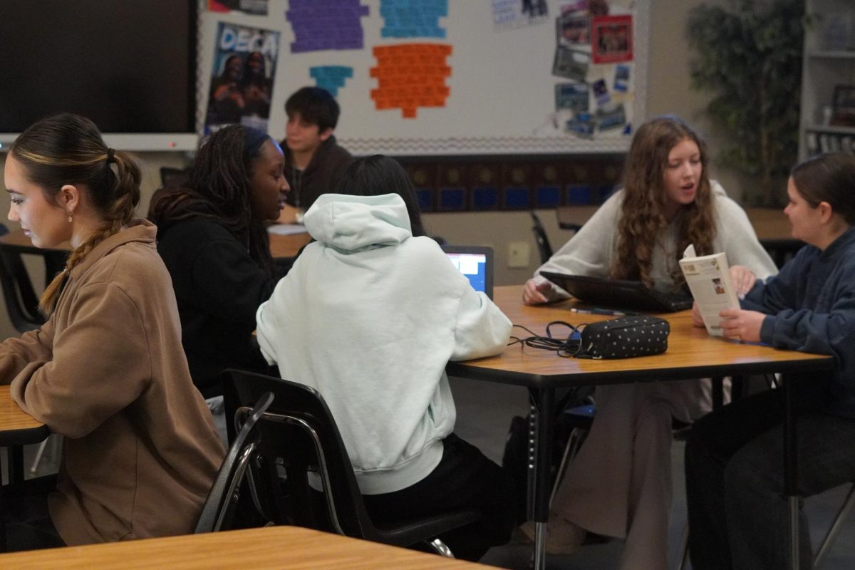 DECA students discussing amongst themselves about upcoming competition in February. 