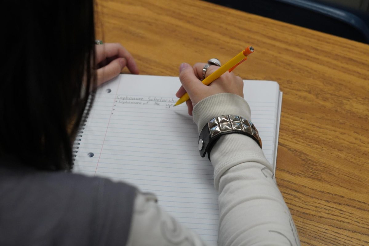 Sophomore Ellery Tran writing about the scholarship opportunity.