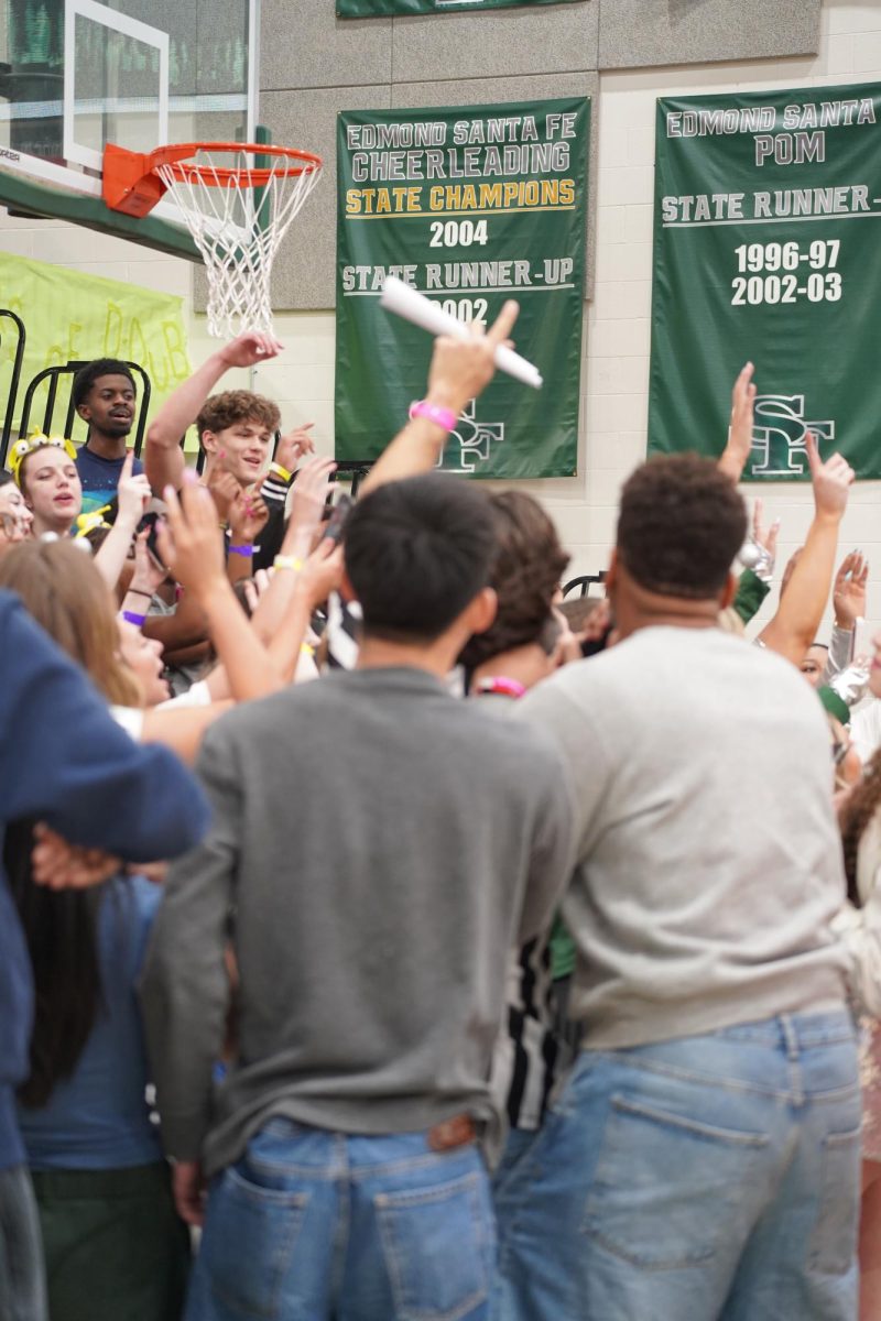 Students crowding together to sing. 