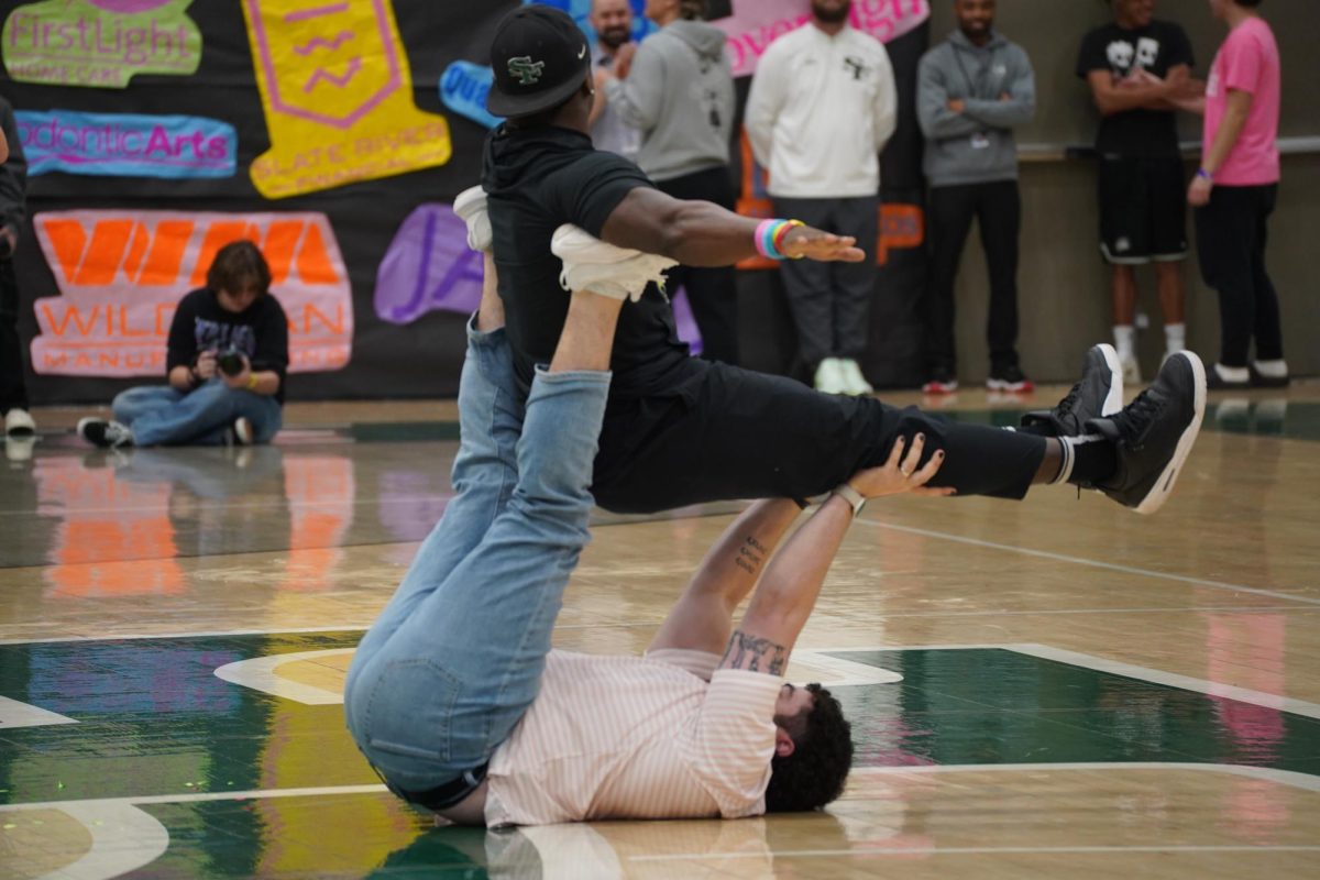 Coach Hurst and Mr.Frazier attempting yoga poses 