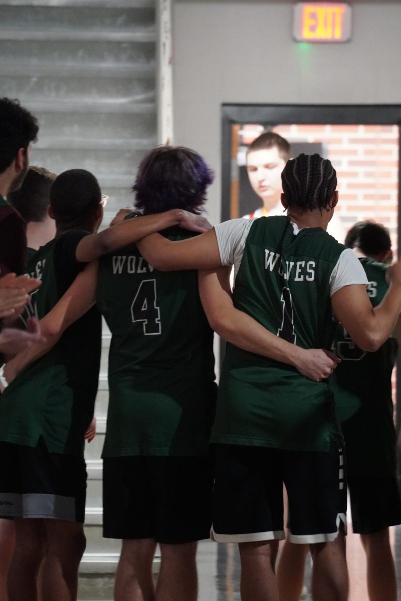 Unified Basketball team huddling together.