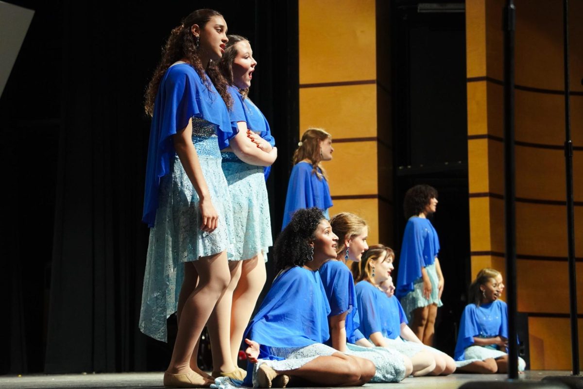 Serenade posing in groups during their song "Rainbow."