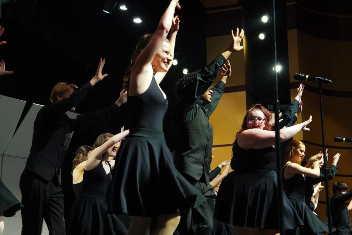 Seniors Alyssa Hargiss, Madilynn Greenwood and other Finalé members dancing to "A Musical."