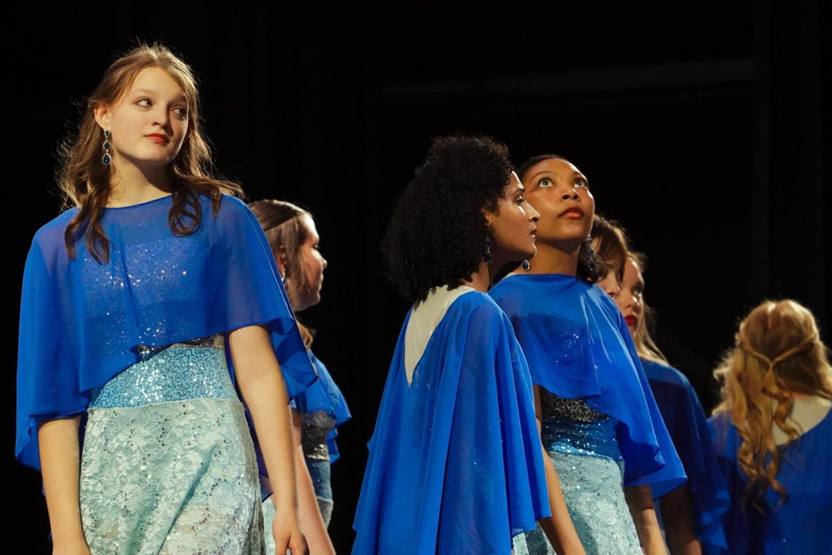 (Left to right) Sophomore Caroline Brooke, freshman Aleise Muse, senior Alycia Rouson and other Serenade members during "Rainbow."