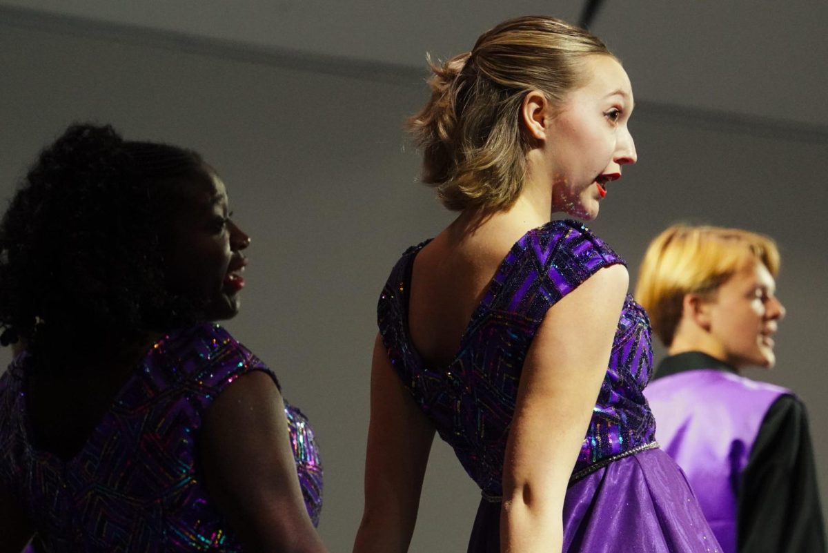 (Left to right) Senior Kayla Eyabi, juniors Genevieve Young and Reid DeGroot during the entrance of "Zazz."
