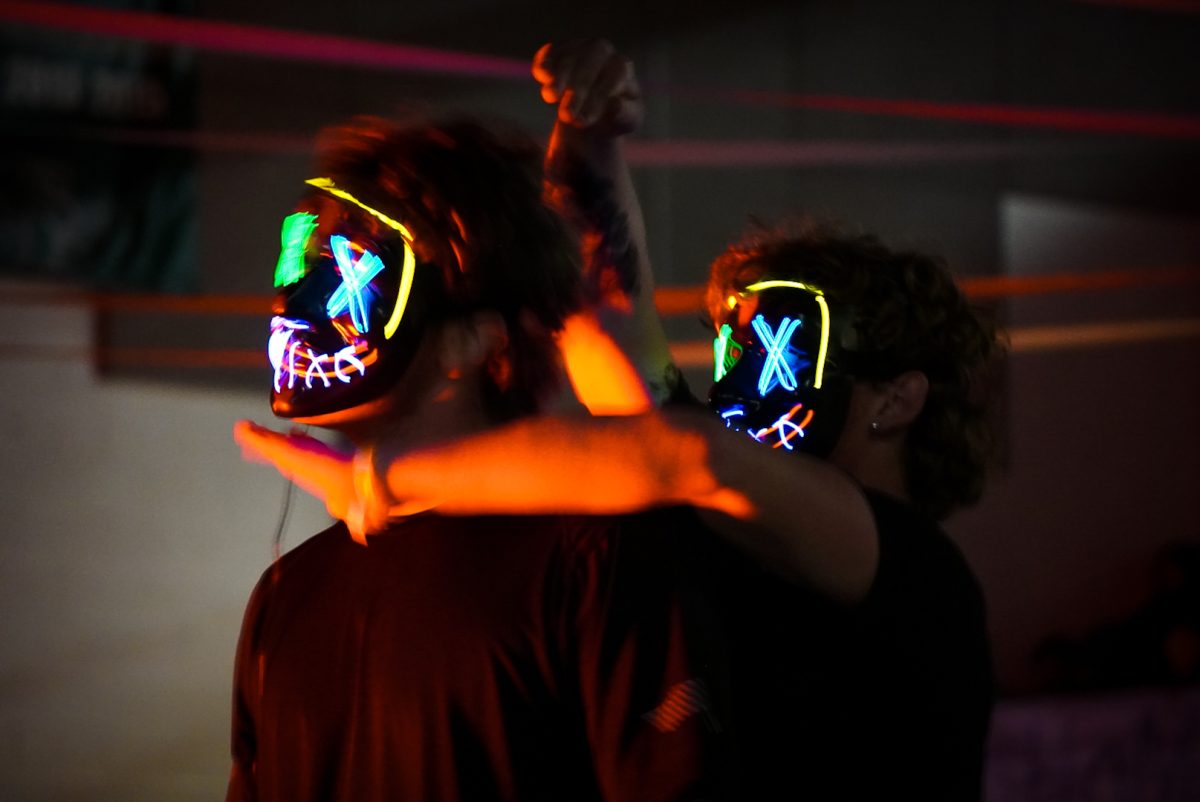 Caleb Cumpton (left) and Boston Stovall (right) wearing light up purge masks recreating a popular Tik Tok dance to the song "Earned It" by The Weeknd.