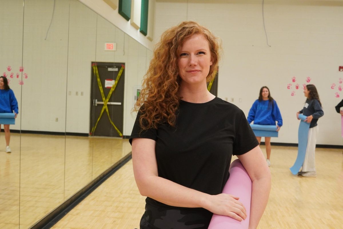 Psychology teacher Kaitlin Powers holding a yoga matt after the yoga practice. 