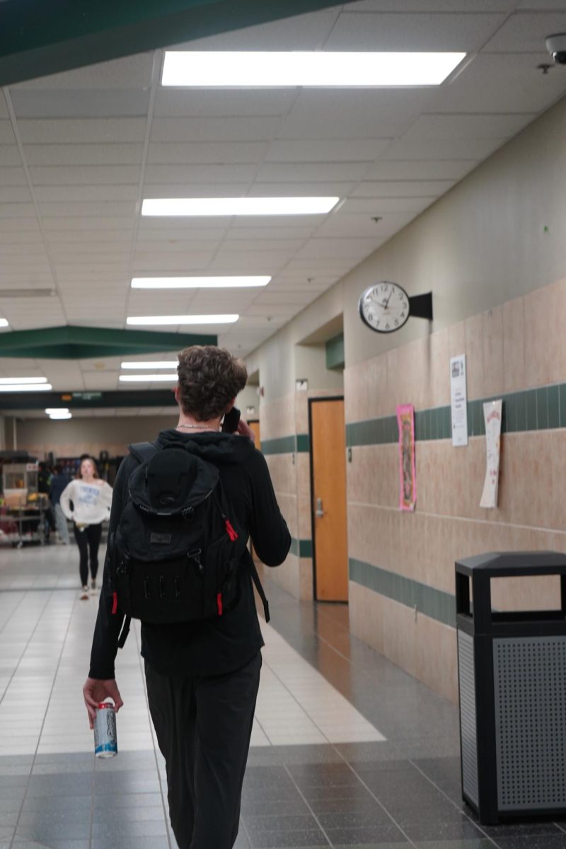 Student being caught on his phone in the middle of the hallways during school hours. 
