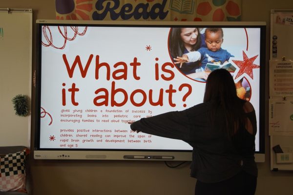 Sophomore Nicole Casada explaining the book drive to a class.  