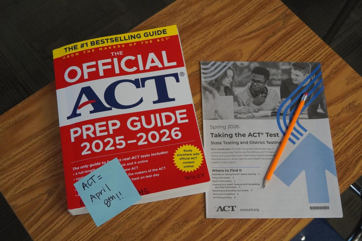 This year's official ACT prep guide beside the pre-test booklet.