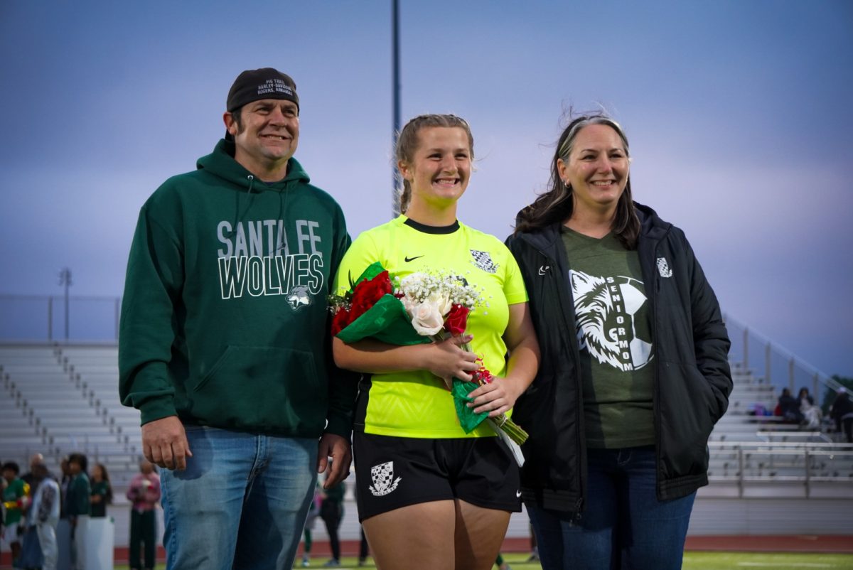 Senior and goalie Allisa Dumas with her parents. 