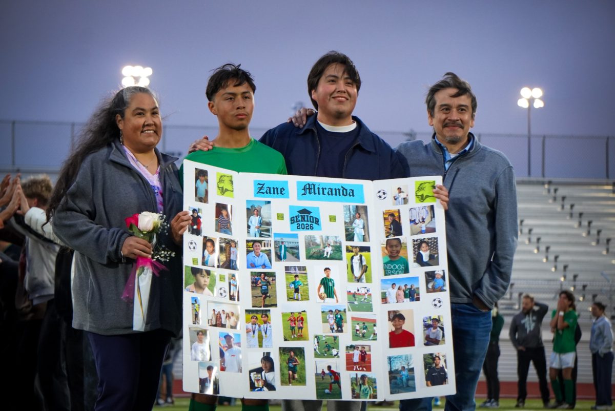 Zane Miranda pictured with his family with a poster board dedicated to him. 