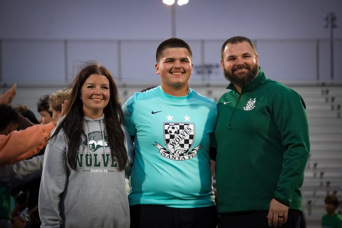 Kayden Mullins a goalie on Santa Fe boys Varsity team with his parents.