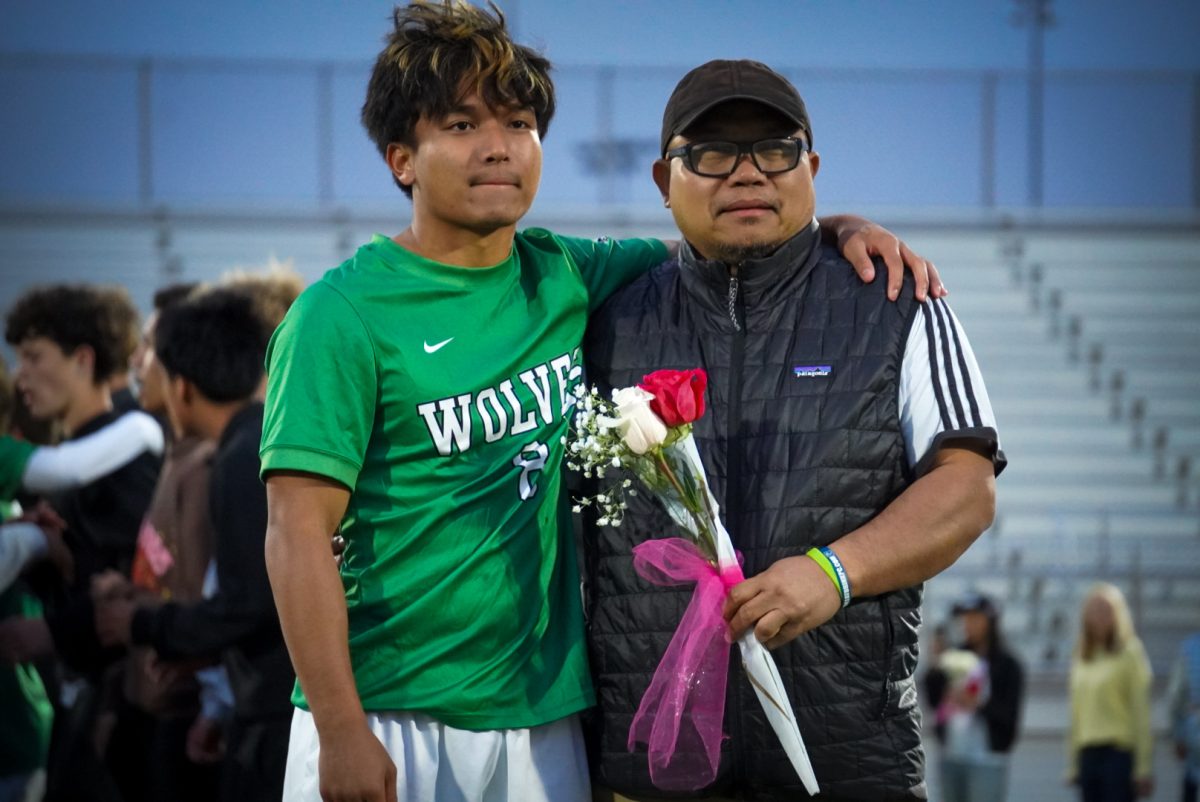 Khai Sang with his father on the field. 