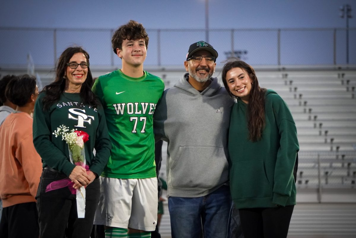 Brody Smith, number 77, posed with his family on the field.
