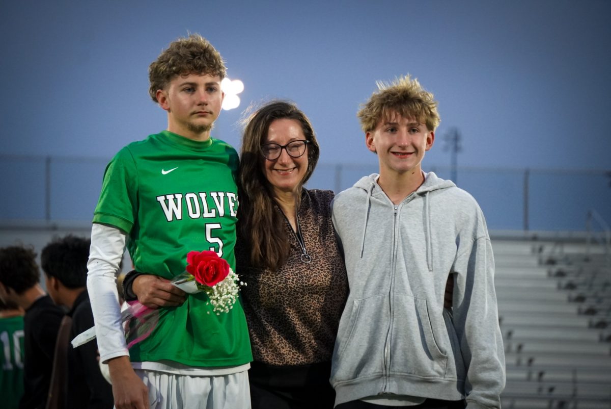 Evan Varner with his mother and younger brother under the stadium lights. 